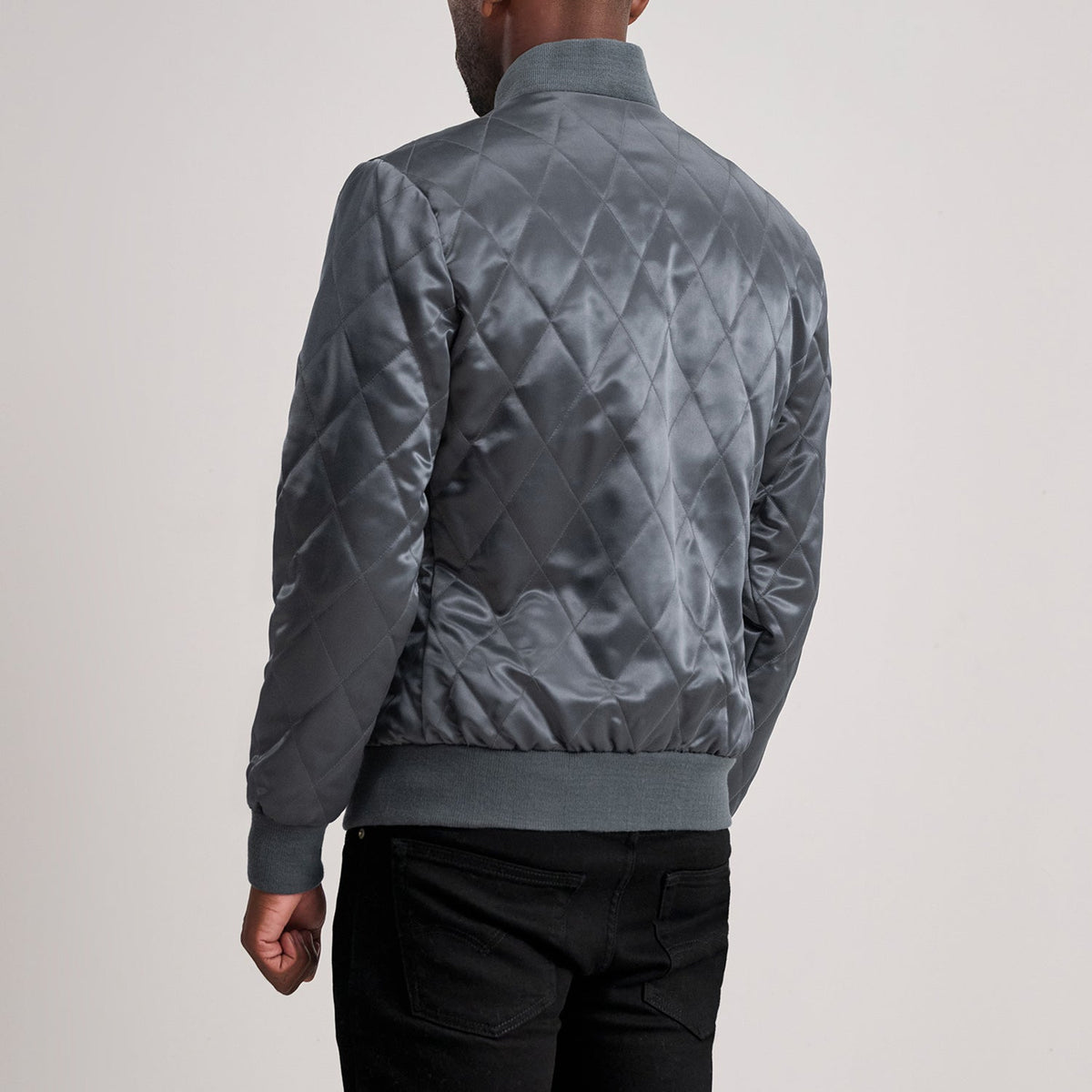 Close-Up Detail of Varsity &amp; Zipper Hardware on Danson Quilted Grey Varsity Jacket
