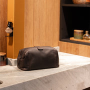 Styled Fit Perspective of Vince Full-Grain Leather Toiletry Bag on Model - Natural Daylight Drape