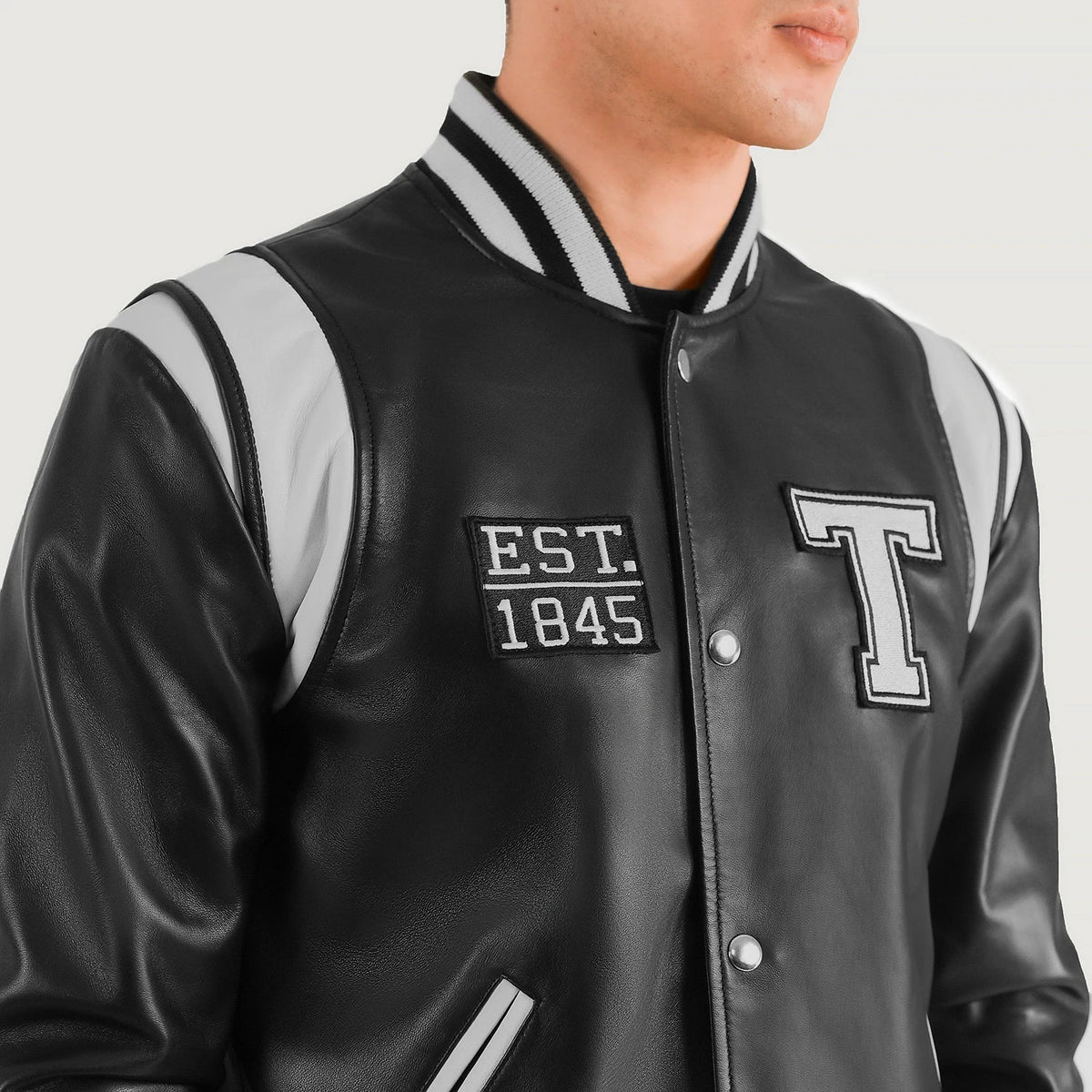 
Close-Up Detail of Varsity & Snap Button Hardware on Liberte Texas Black Leather Varsity Jacket