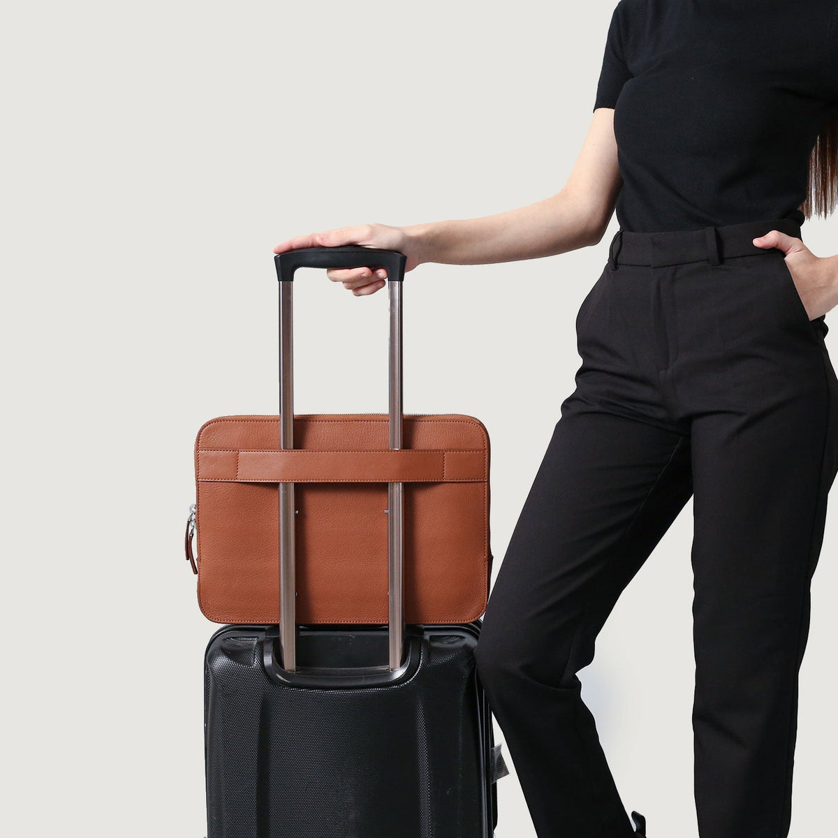 
Styled Fit Perspective of The Baxter Brown Leather Laptop Sleeve For Men & Women on Model - Natural Daylight Drape