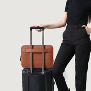 
Styled Fit Perspective of The Baxter Brown Leather Laptop Sleeve For Men & Women on Model - Natural Daylight Drape