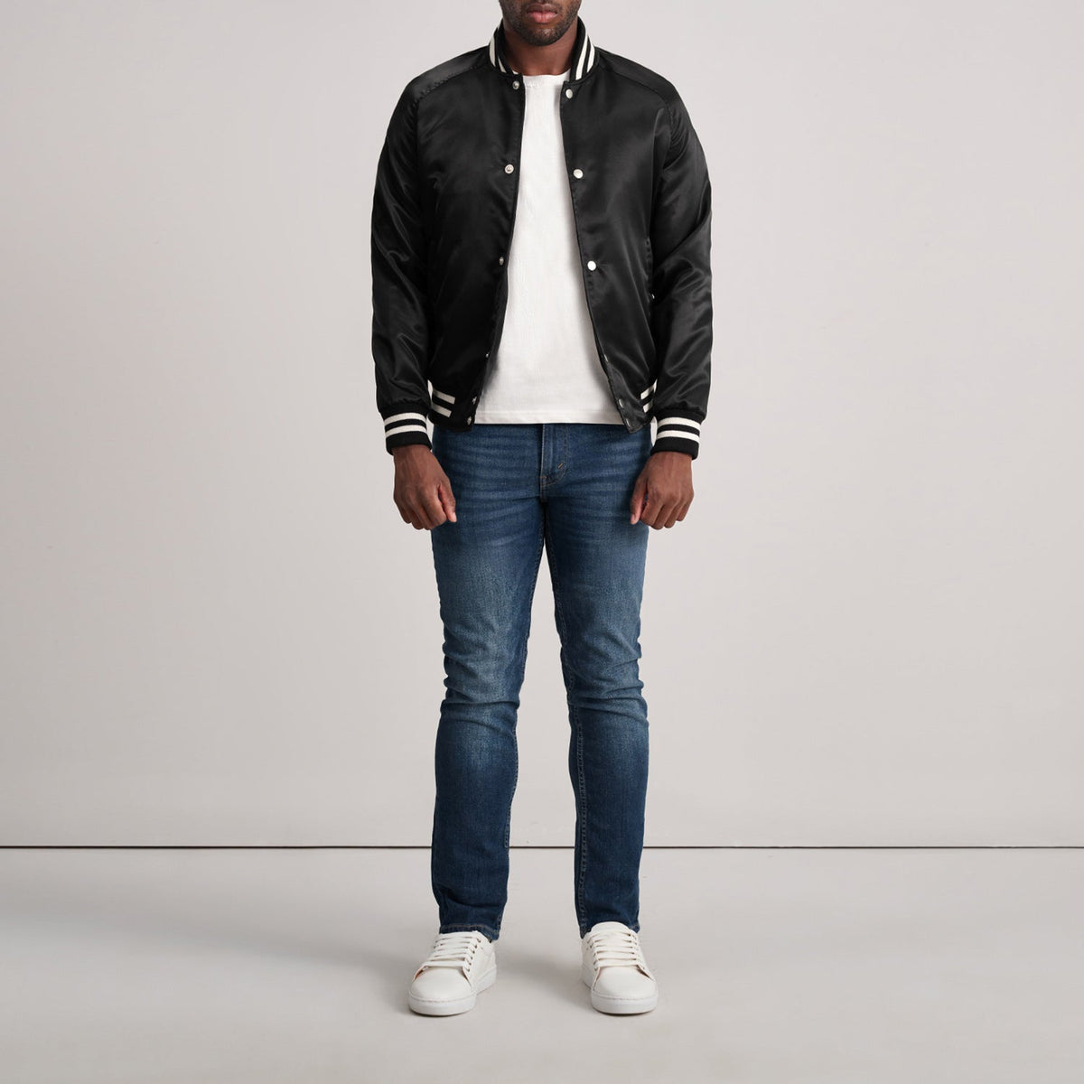 Close-Up Detail of Varsity &amp; Button Hardware on Xander Black Varsity Jacket